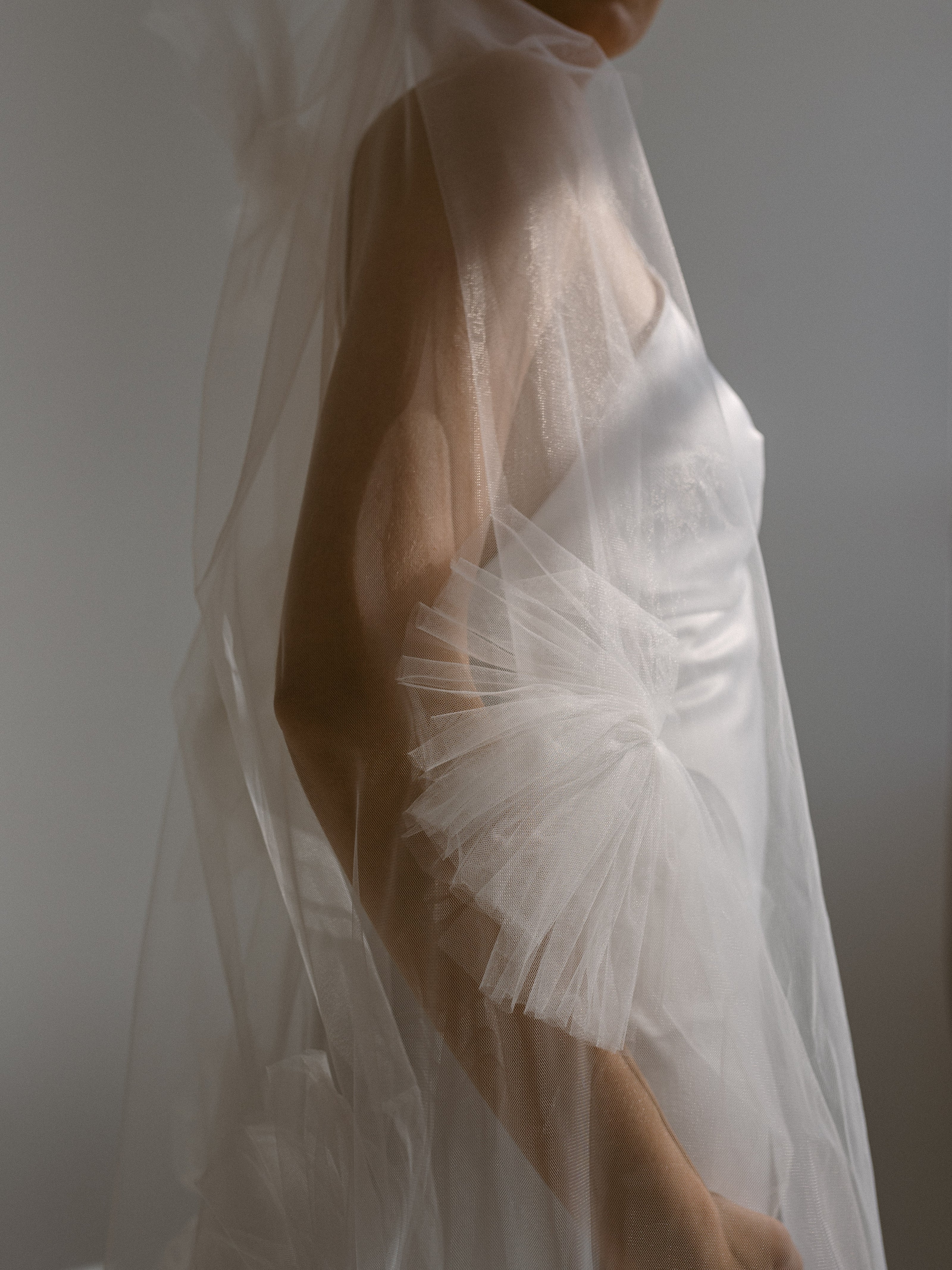 A closeup of an oversized tassel on a veil.